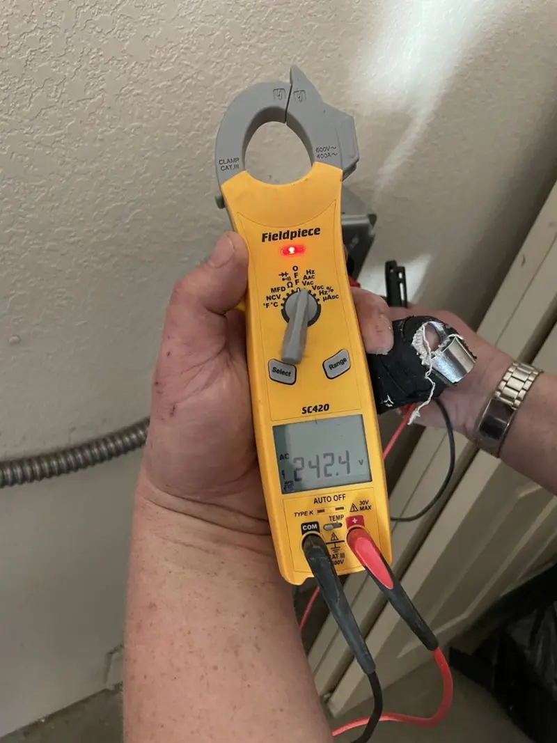 Voltage testing with clamp meter during Outlet Installation in St. Louis